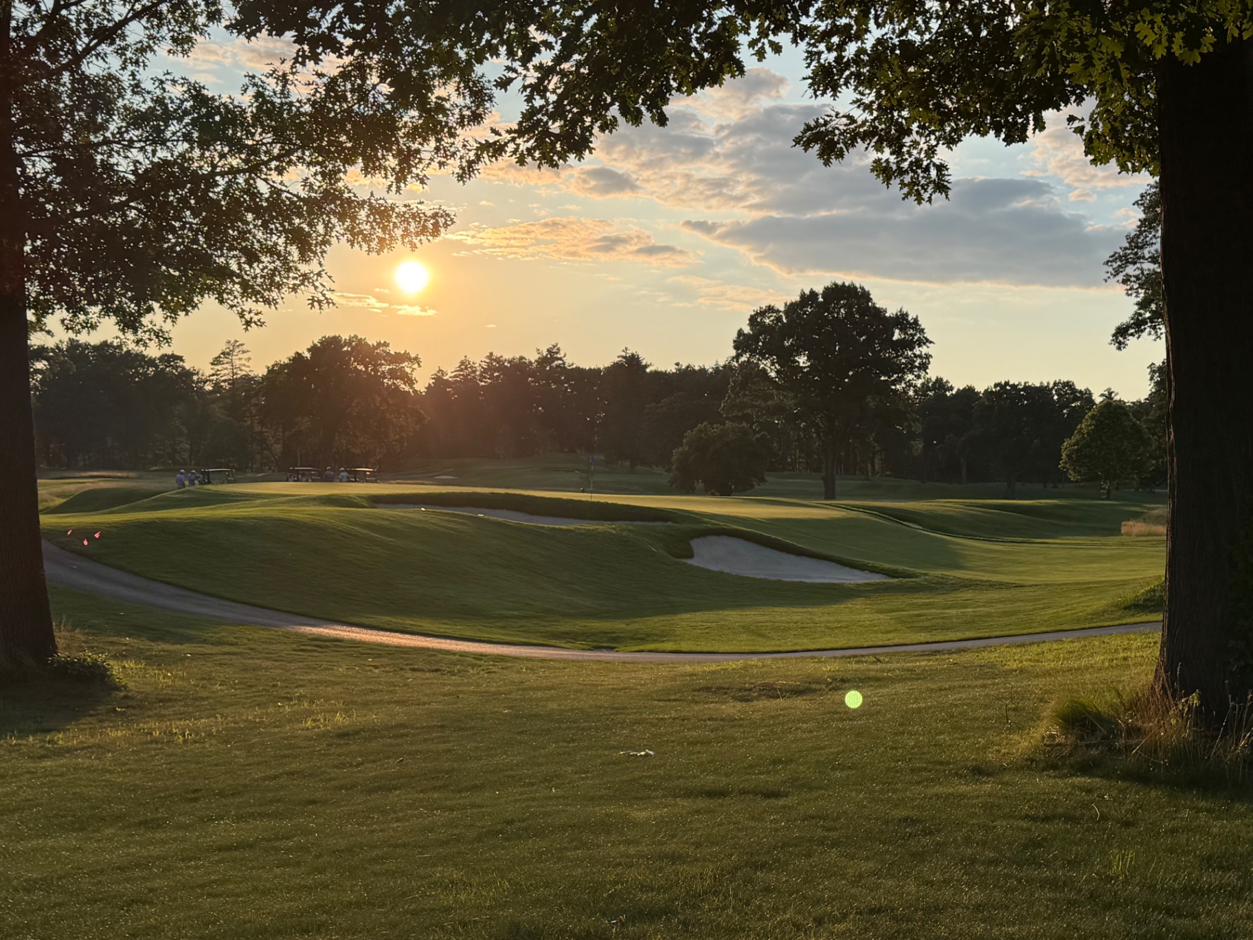 Vesper Country Club course at sunset, fairway and bunkers under the trees